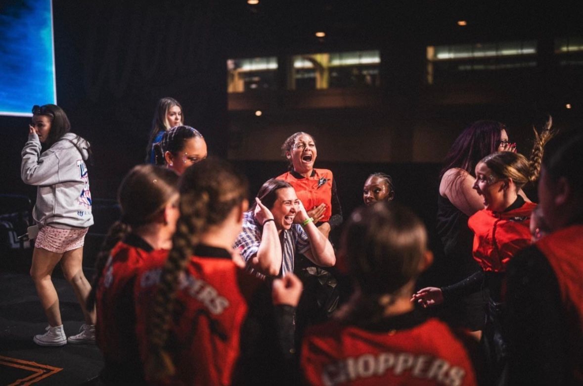A group of people are standing in a dark room.