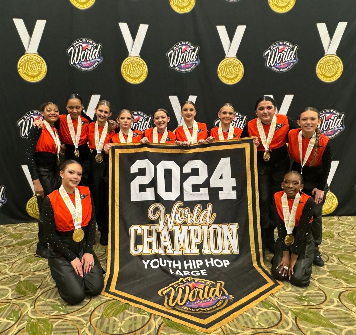 A group of girls holding a banner that says 2024 world champion