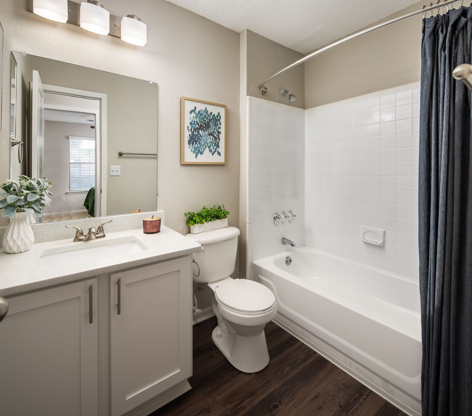 A bathroom with a toilet , sink and bathtub