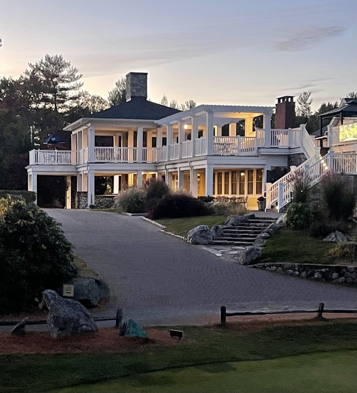 A large white house with stairs leading up to it
