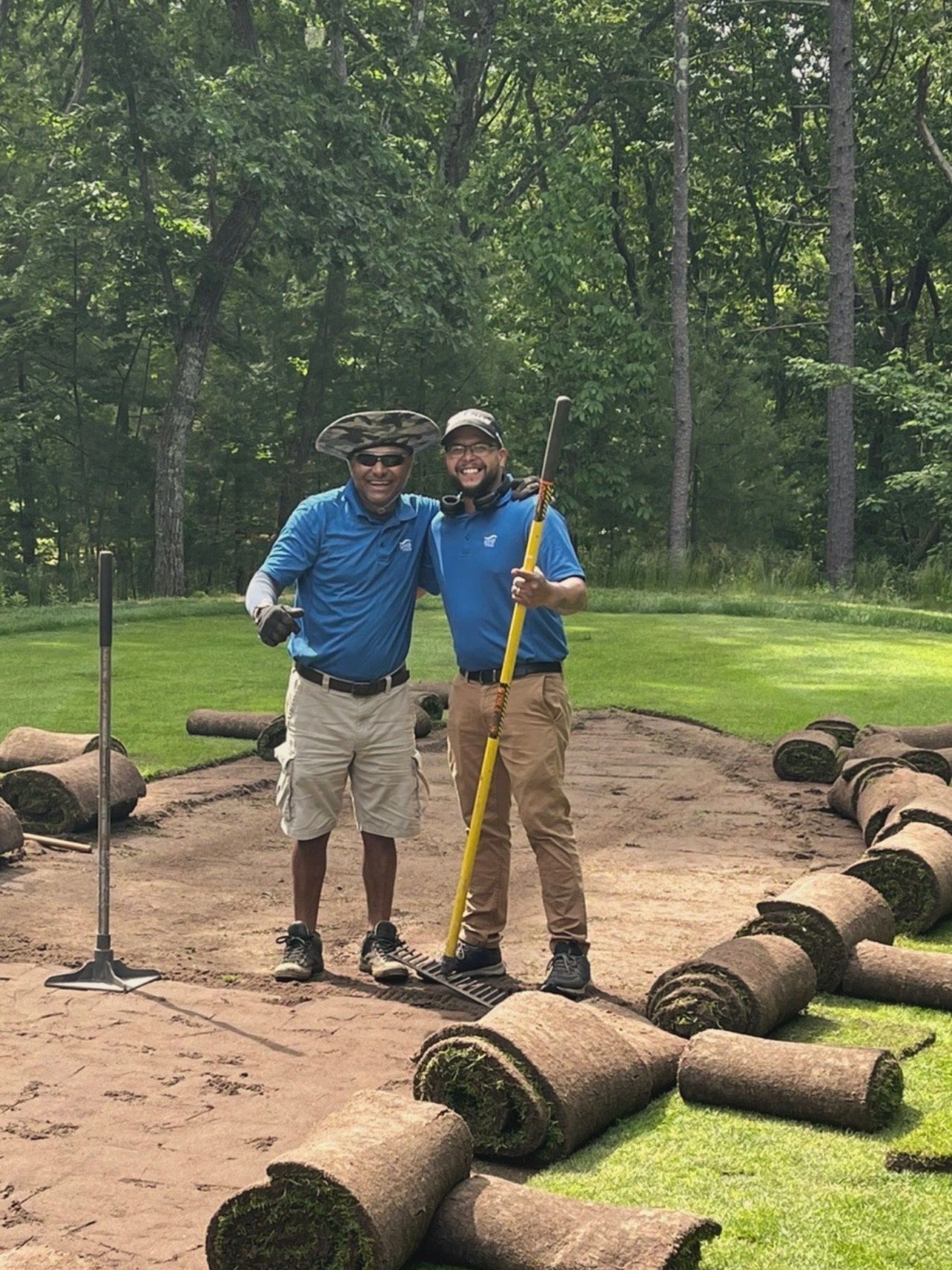 Two men are standing next to each other on a golf course.