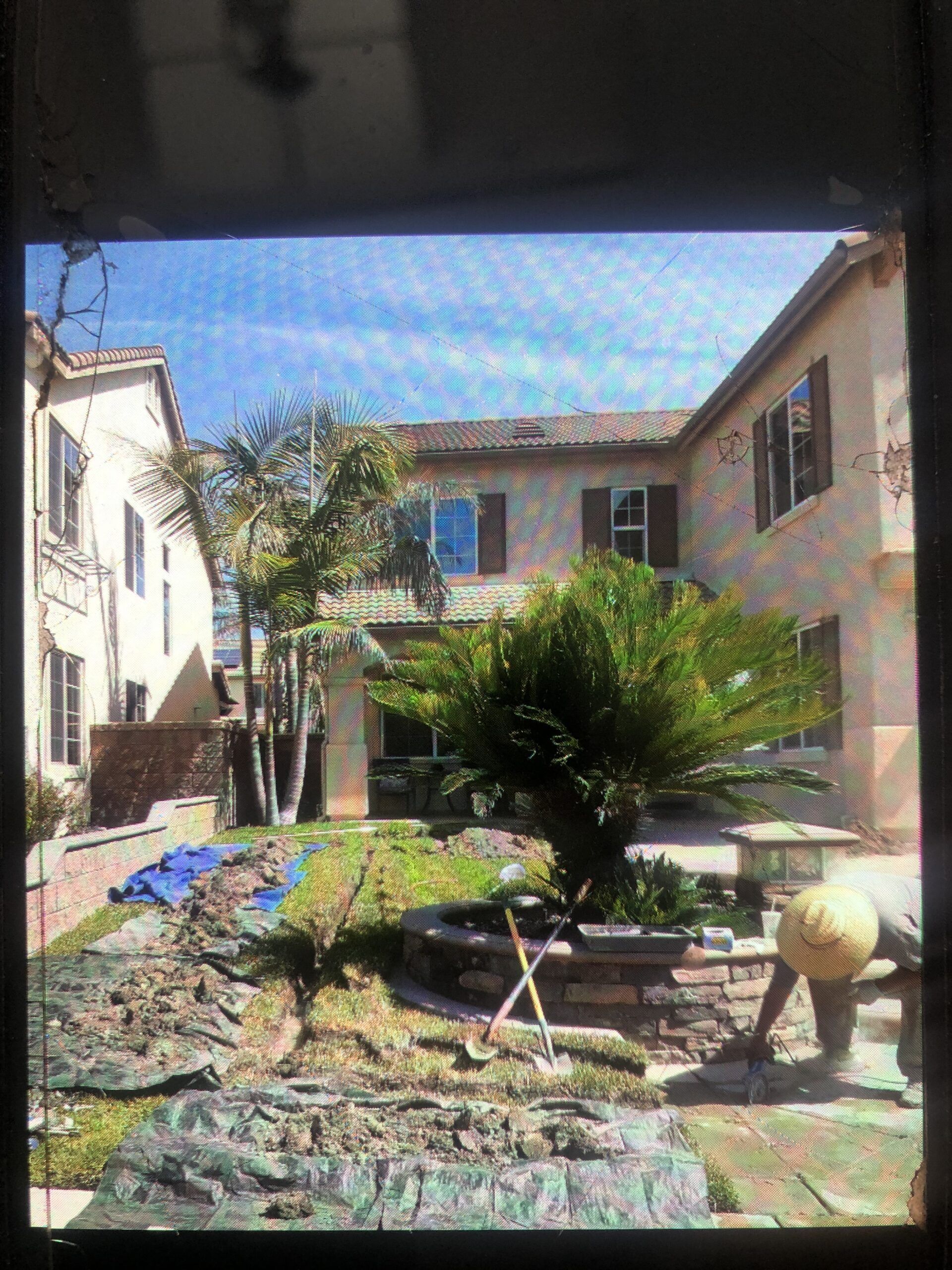 A Man is Working in Front of a Large Building