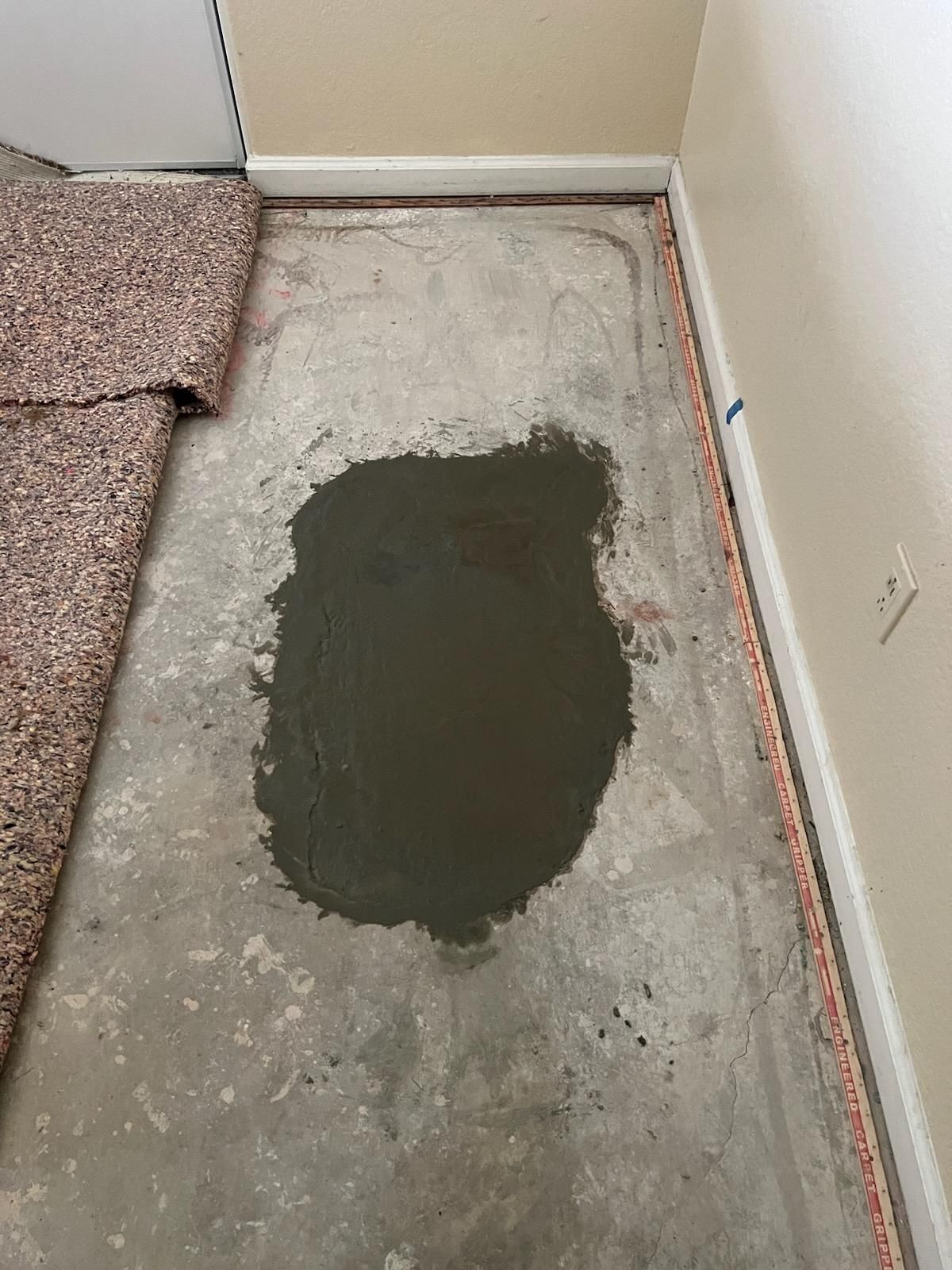 A Large Puddle of Cement is on the Floor in a Room