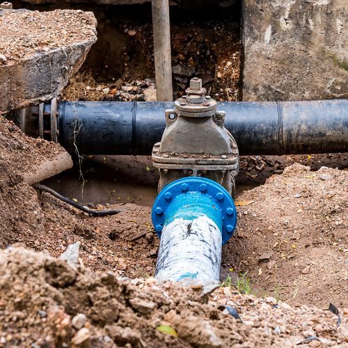 A Blue Pipe is Connected to a Black Pipe in the Dirt