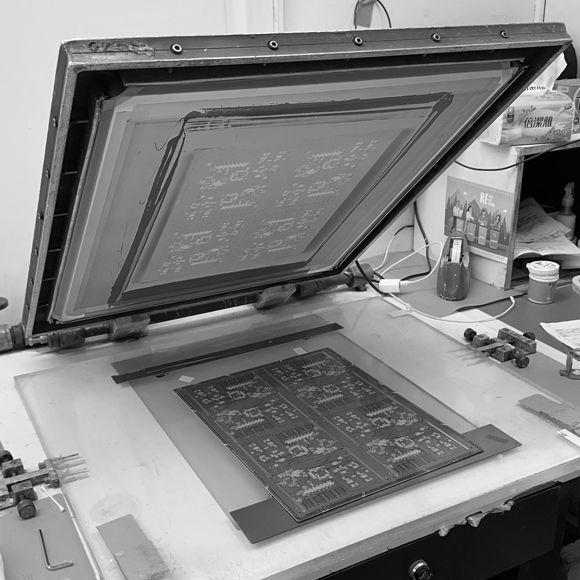 A black and white photo of a screen printing machine