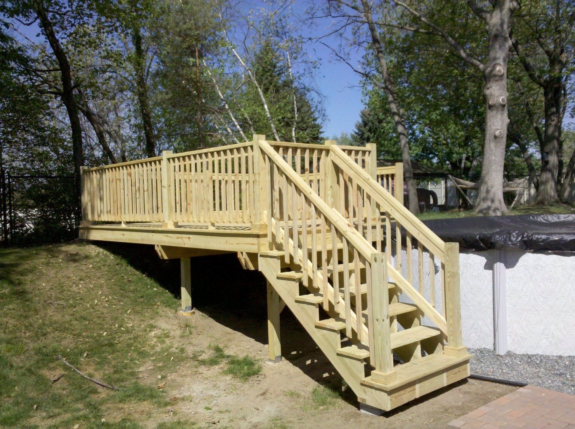 A wooden deck with stairs leading up to it