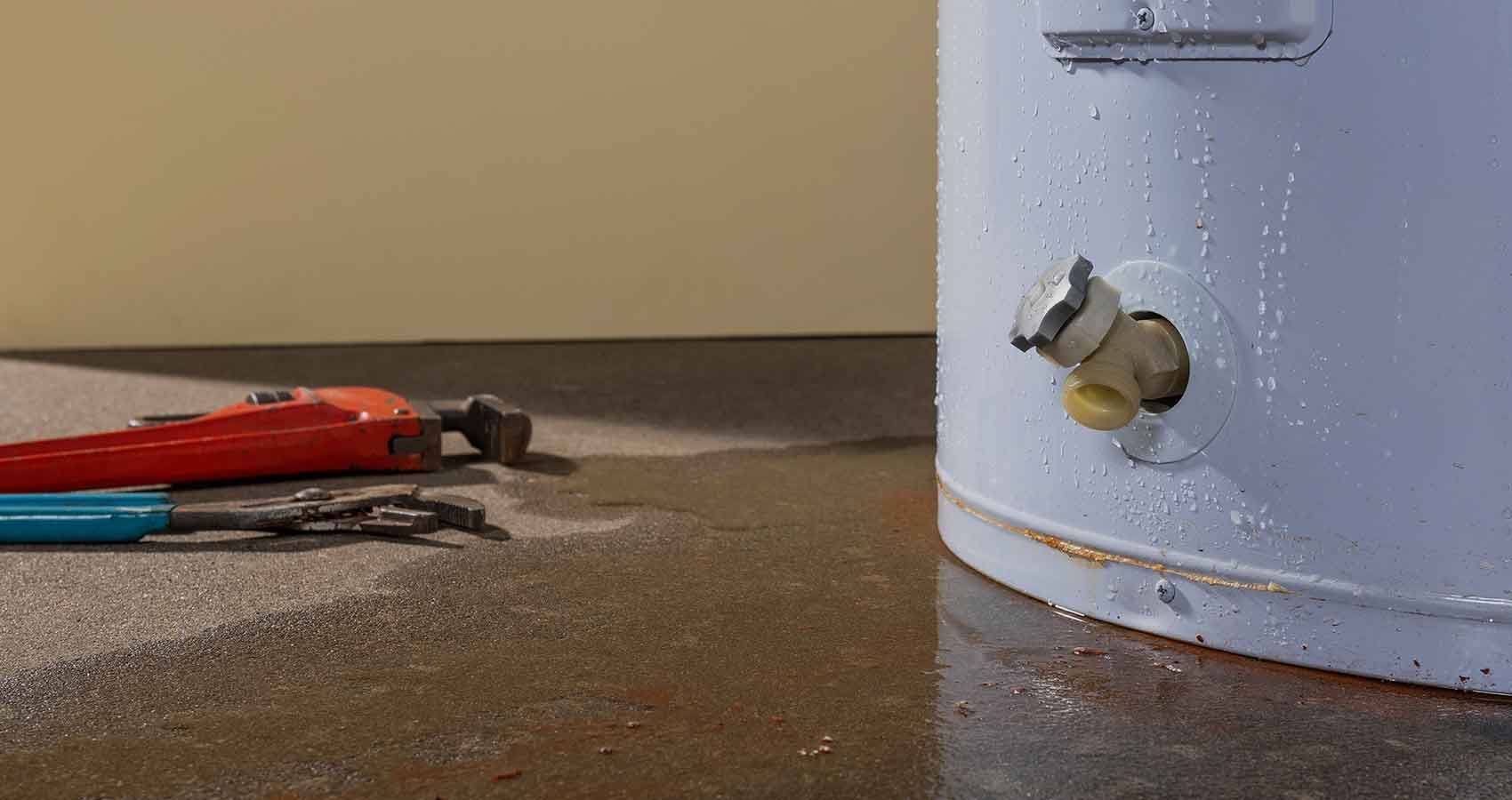 A plumber is fixing a pipe with a wrench.