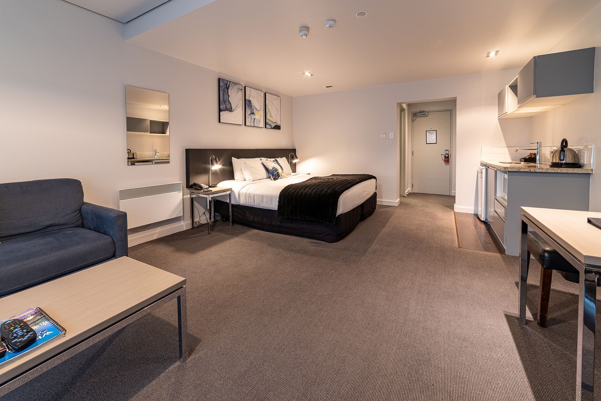 A hotel room with a king size bed and a couch
