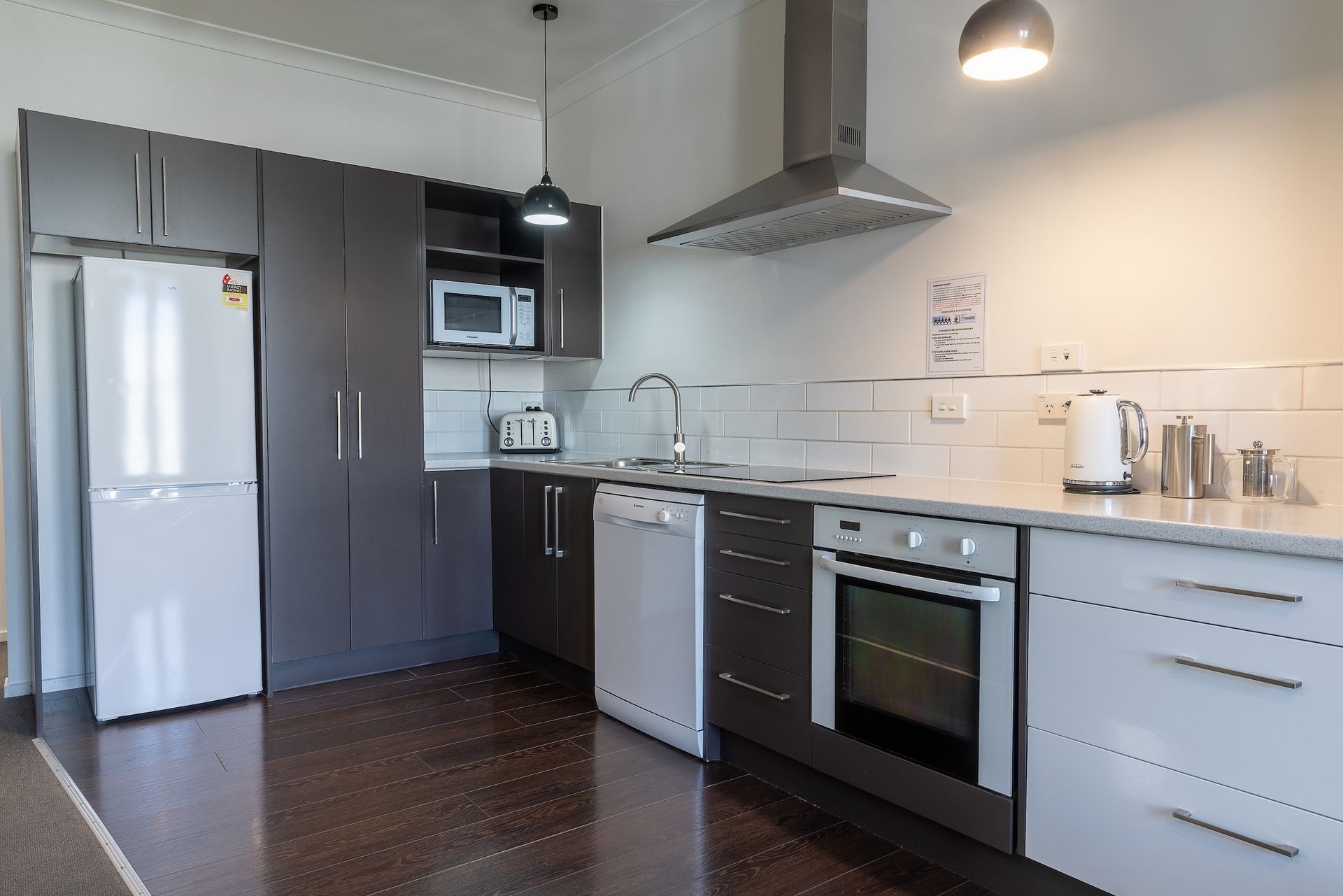 A kitchen with a refrigerator , stove , dishwasher , and microwave.