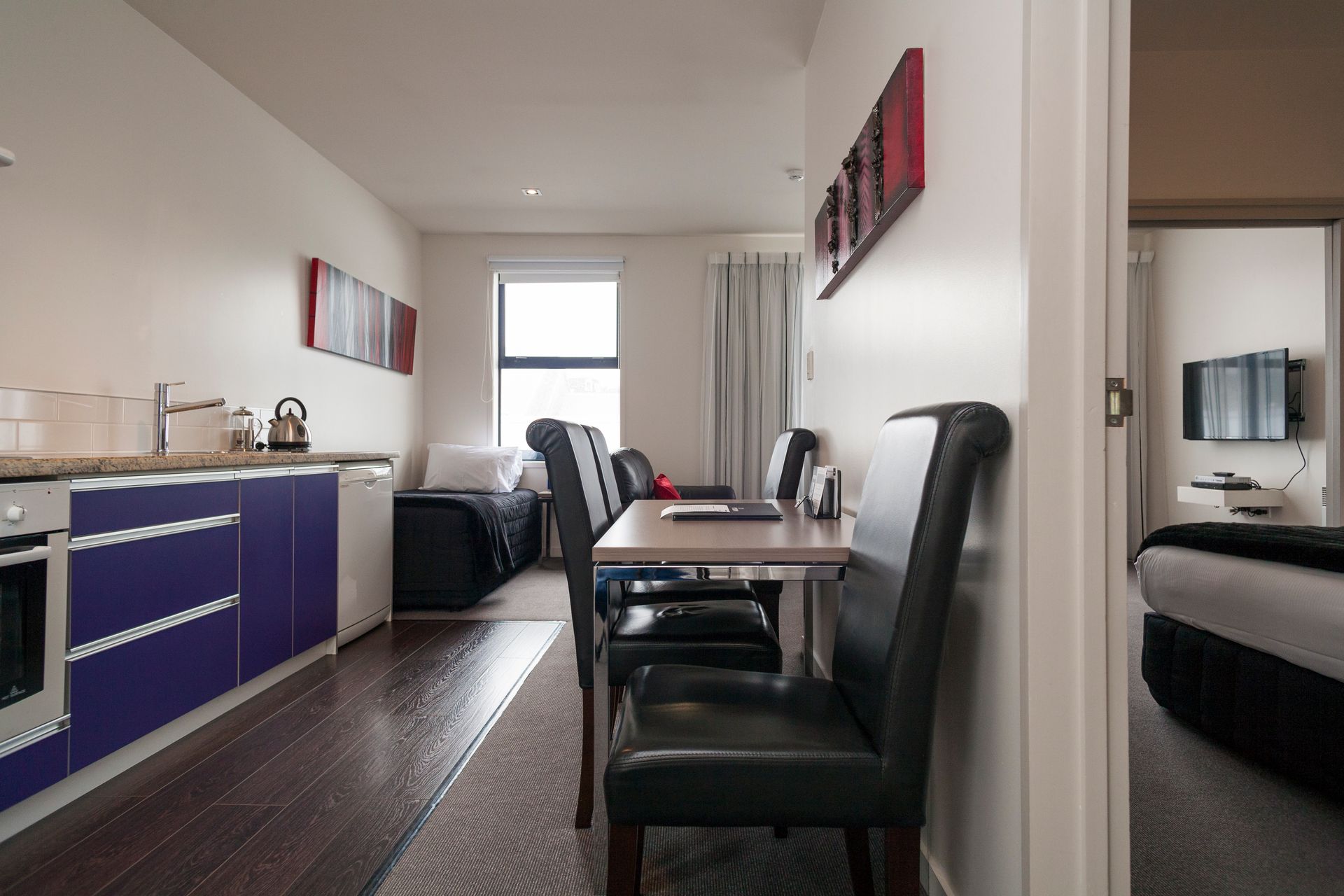 There is a table and chairs in the middle of the room.