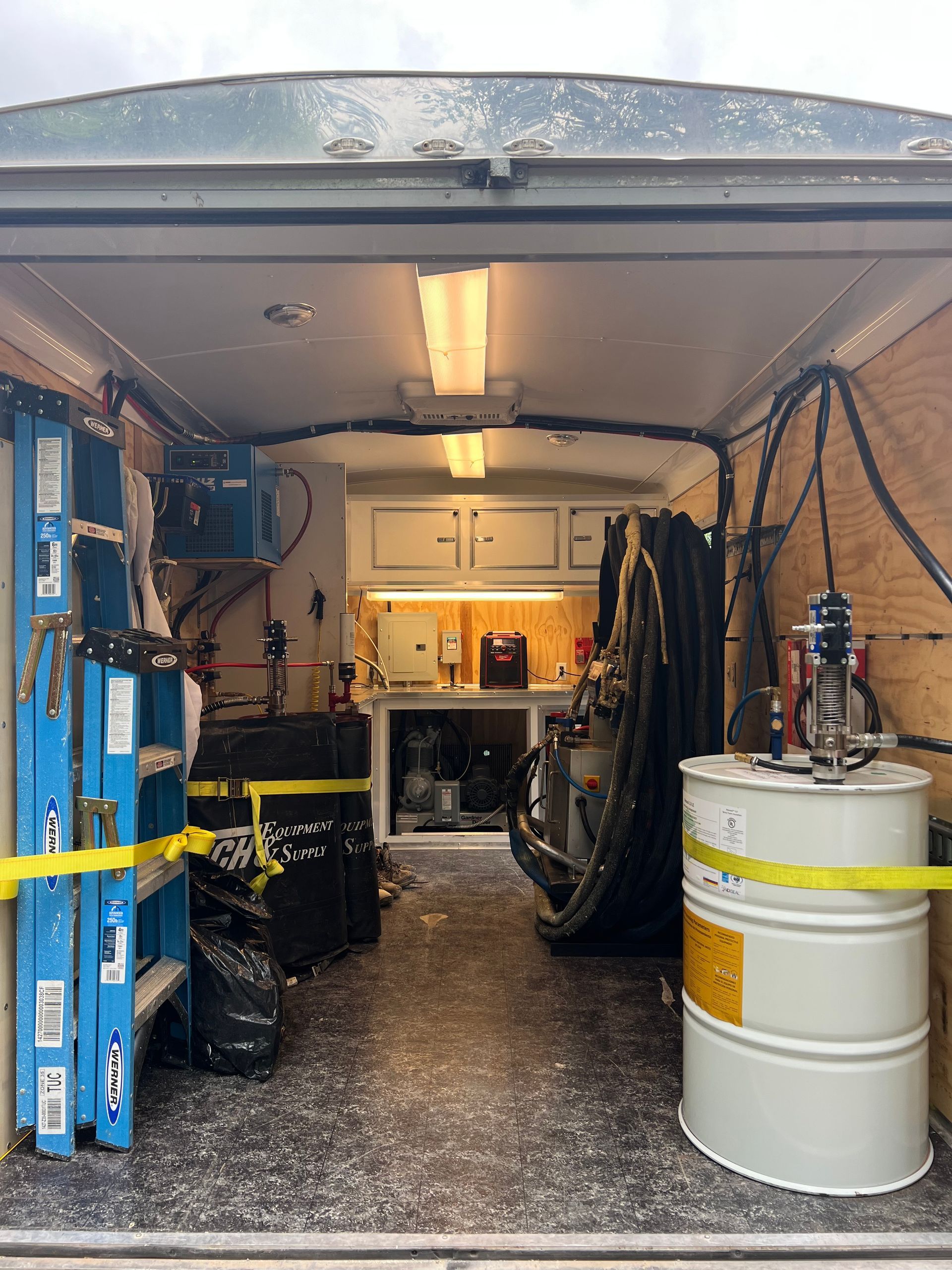 a red and white machine gun laying on a rock