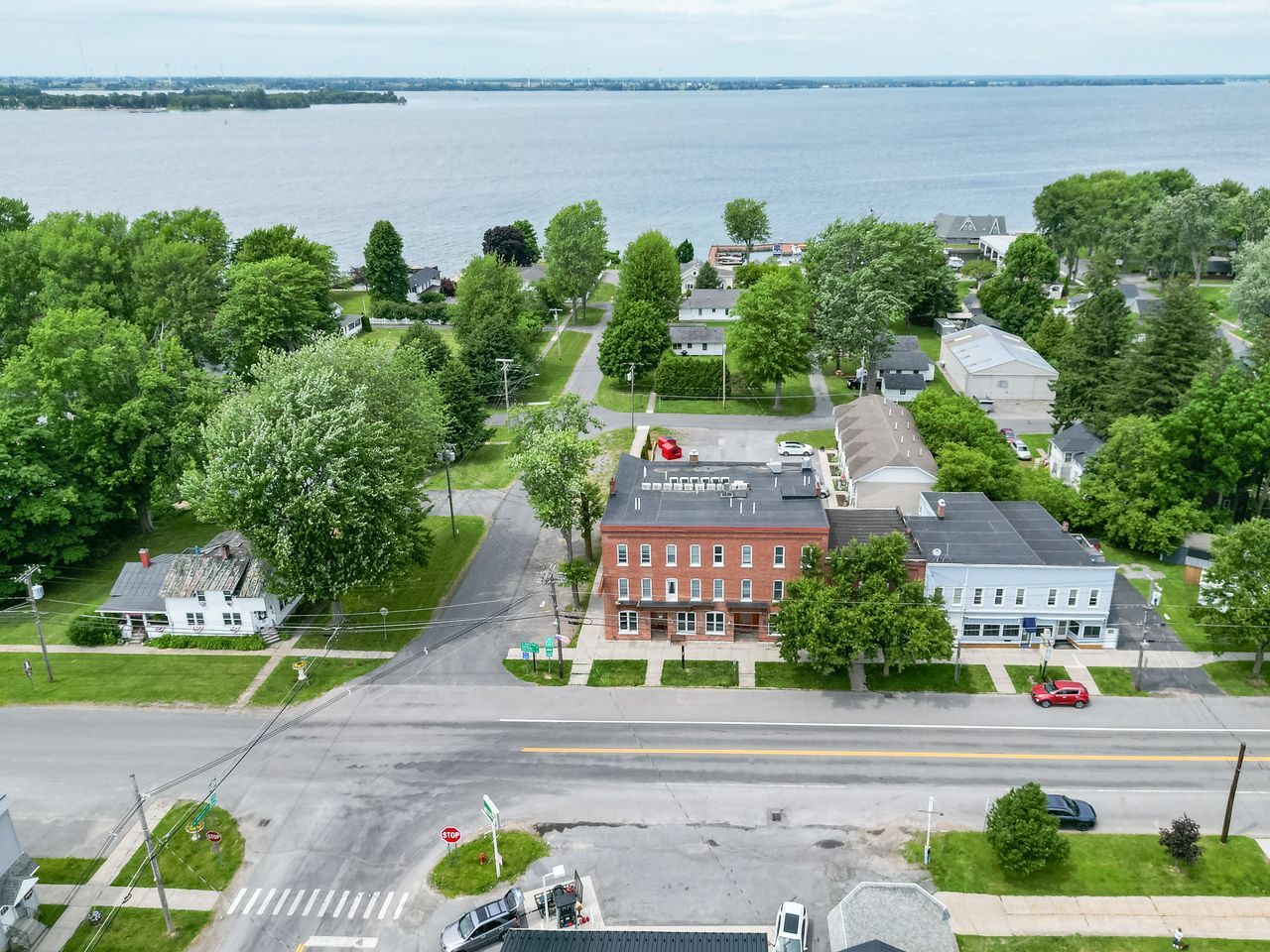 An aerial view of a small town with a large body of water in the background.