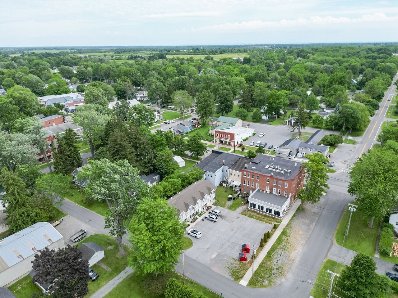 An aerial view of a small town with lots of trees and houses.