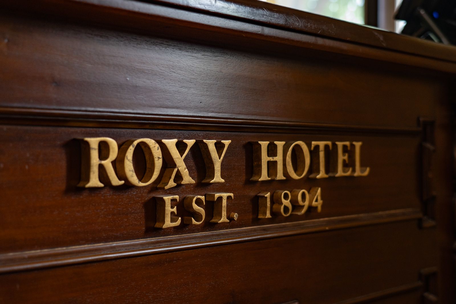 A wooden sign that says roxy hotel on it