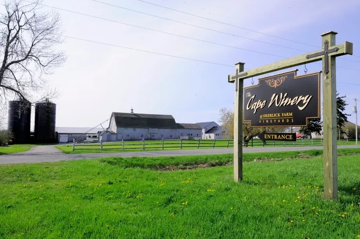 A room with a wooden desk and a stained glass door.