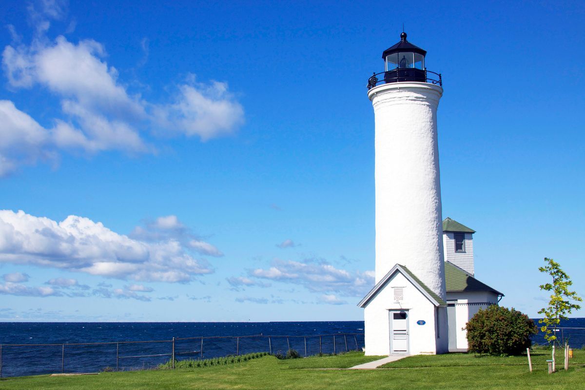 A large brick building with a red car parked in front of it