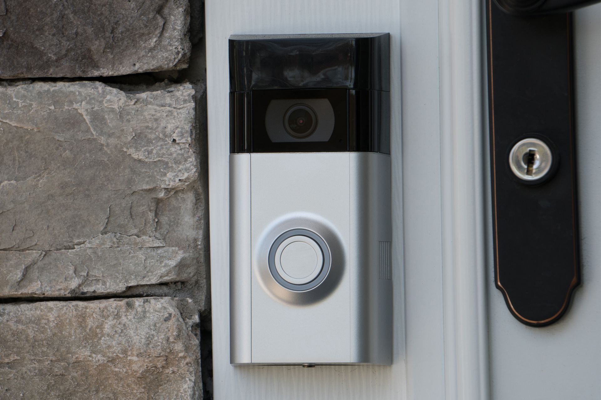 A doorbell with a camera attached to it is on a door