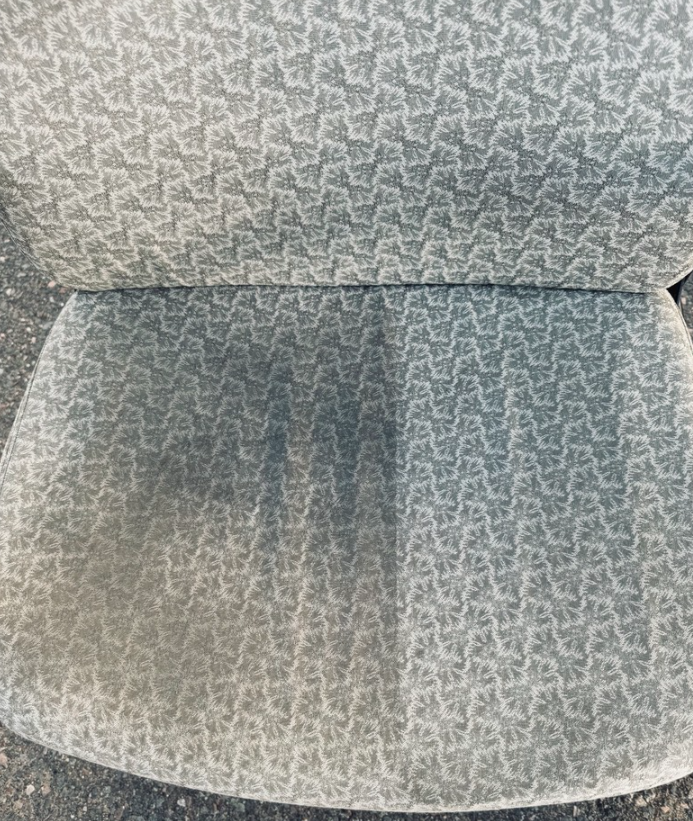 A close up of the back of a chair with a pattern on it.