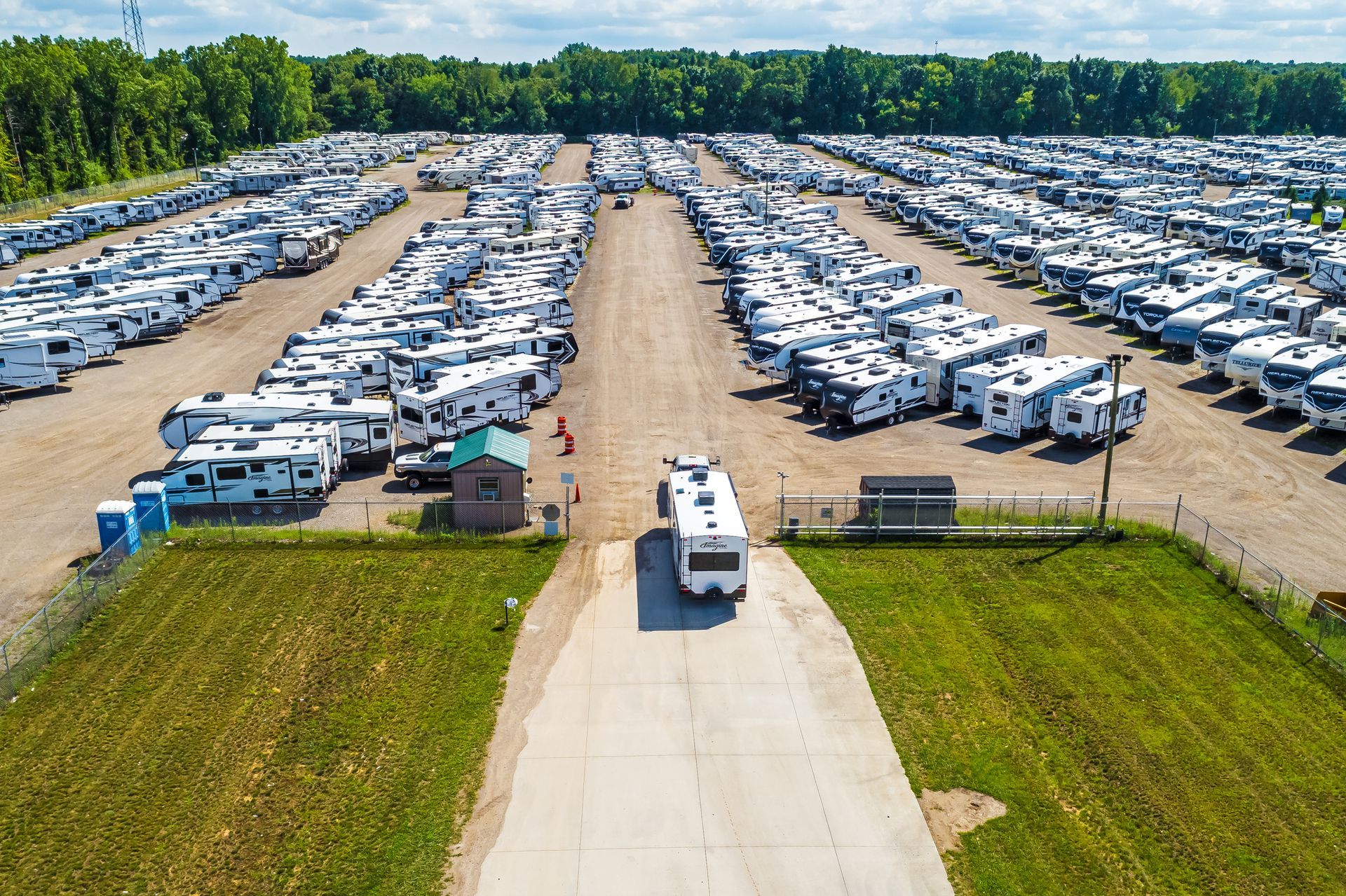 Aerial view of a large RV storage lot with rows of parked recreational vehicles.