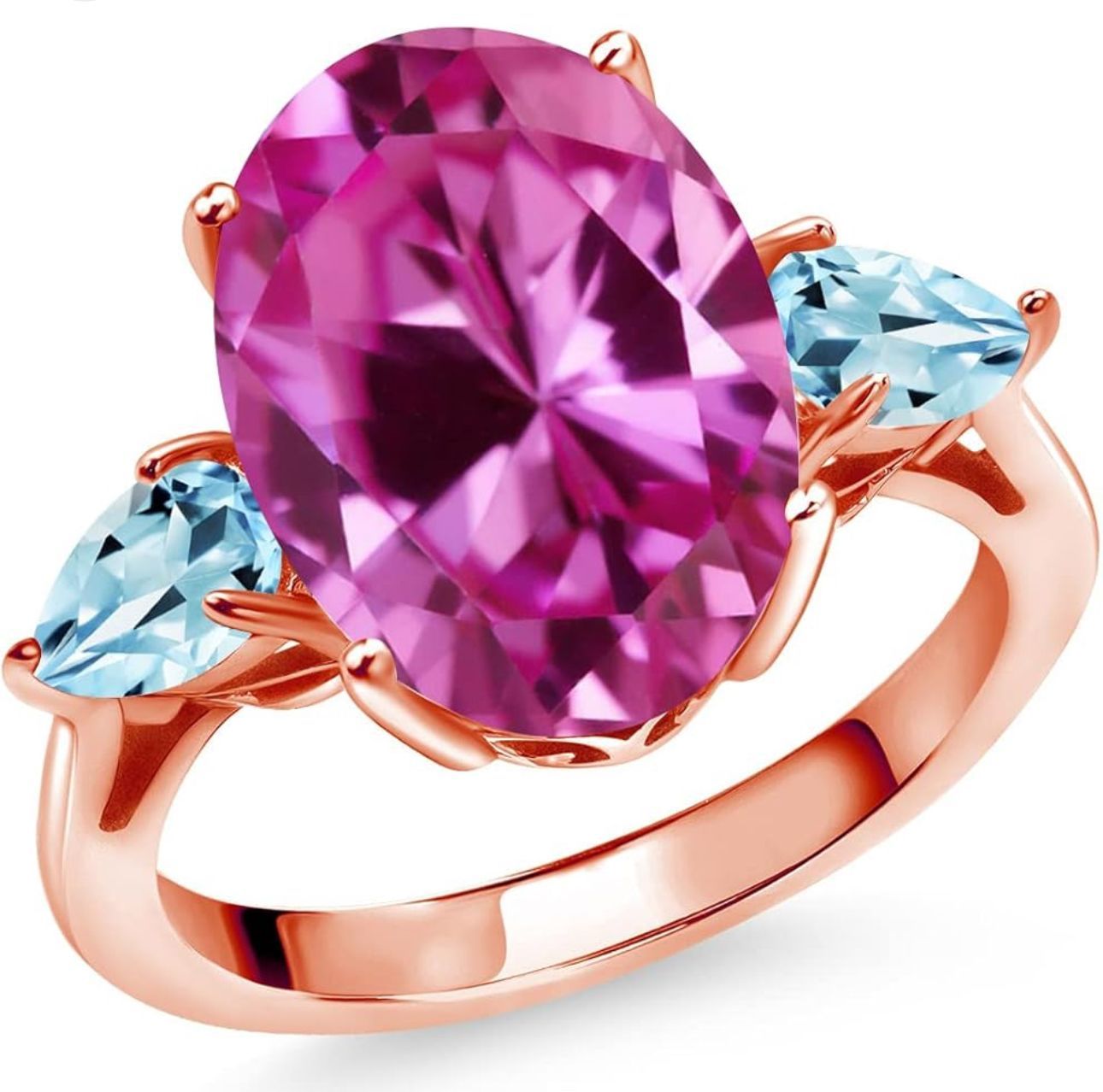 Anillo de oro rosa con una gran piedra preciosa ovalada rosa y dos gemas azules en forma de pera.