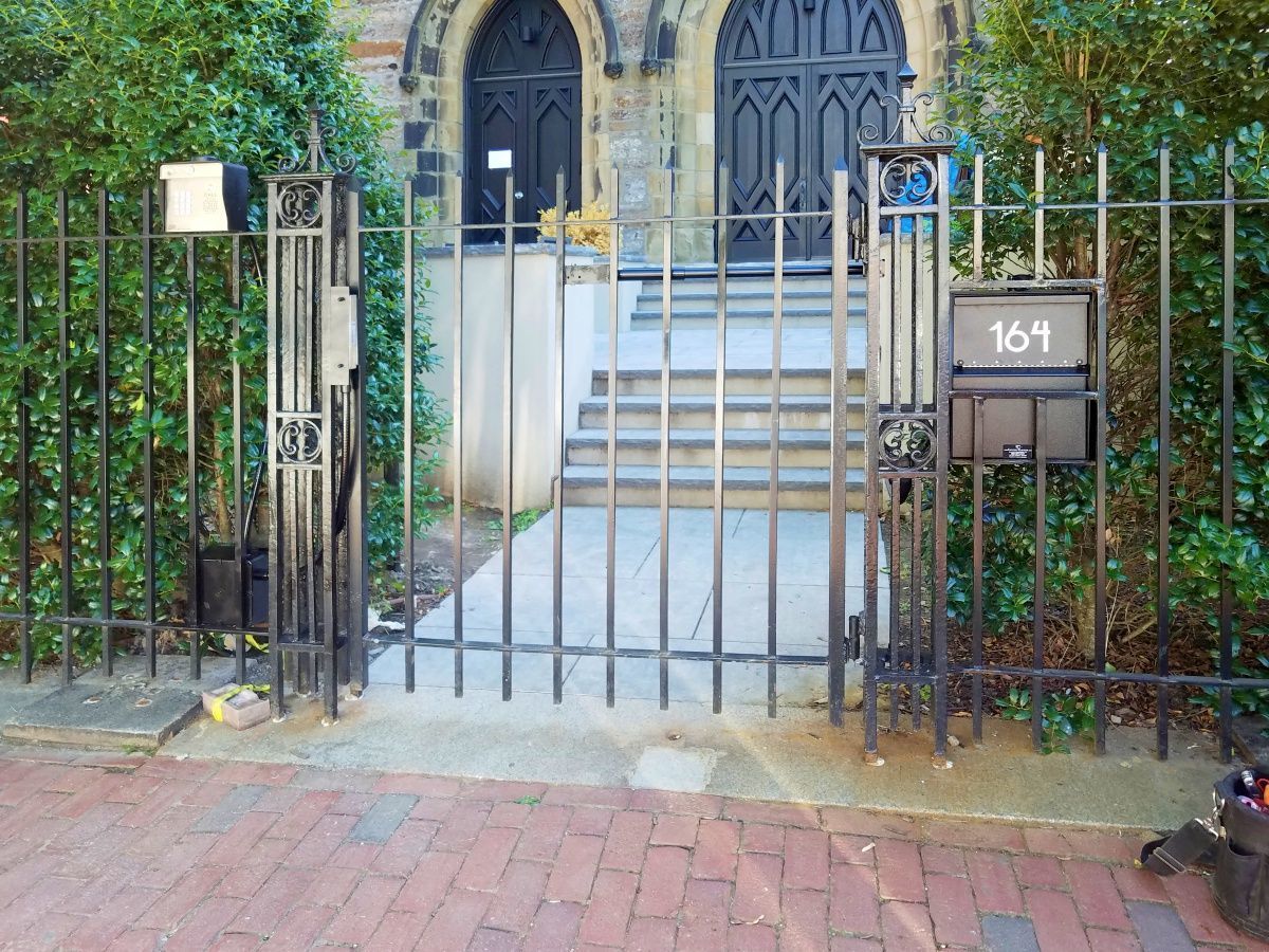 A black mailbox with the number 169 on it