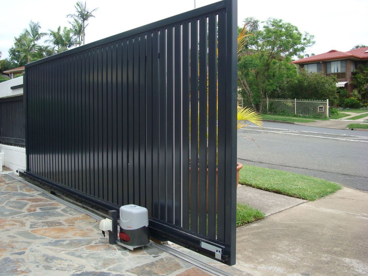A sliding gate with a motor attached to it