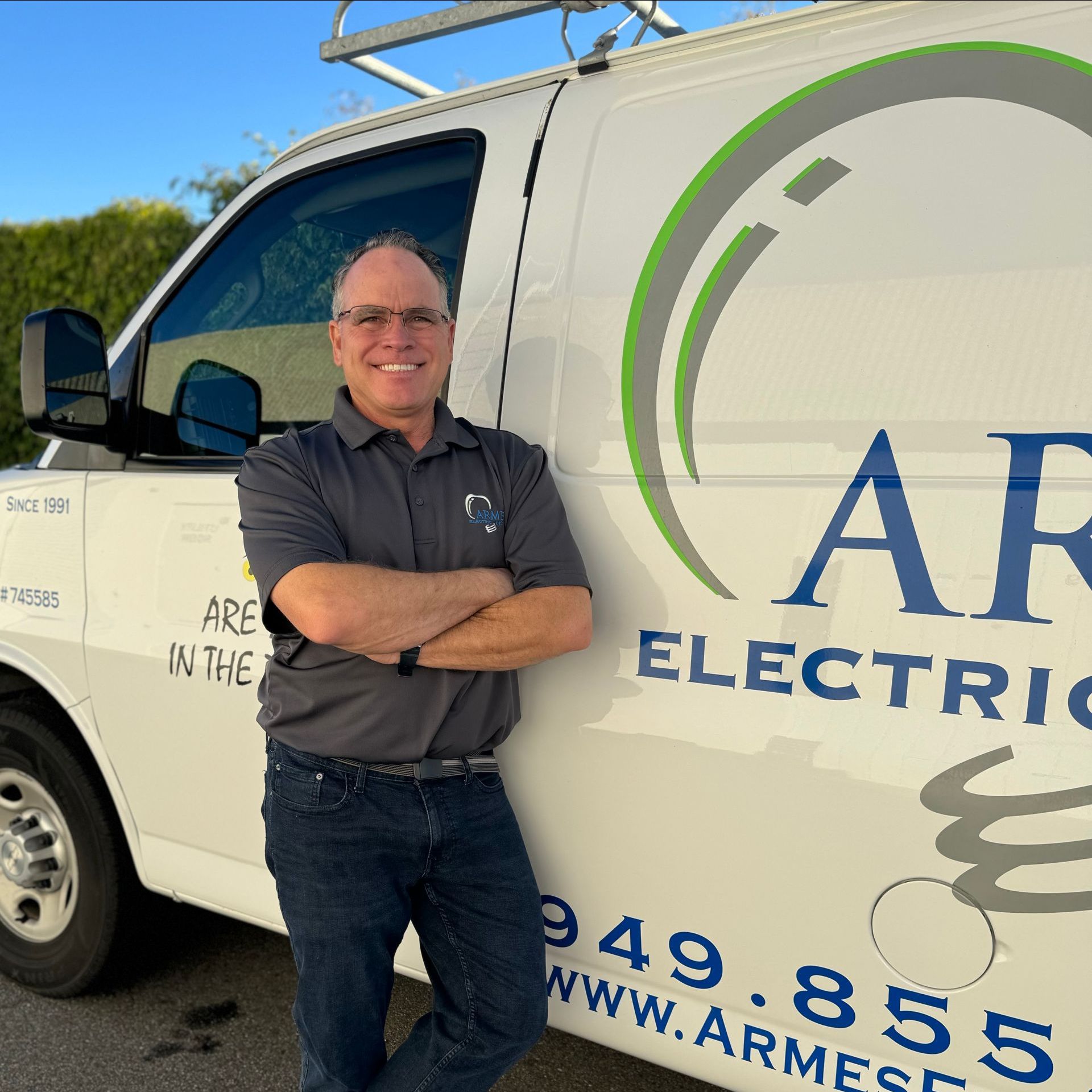 a man stands in front of an arm electric van