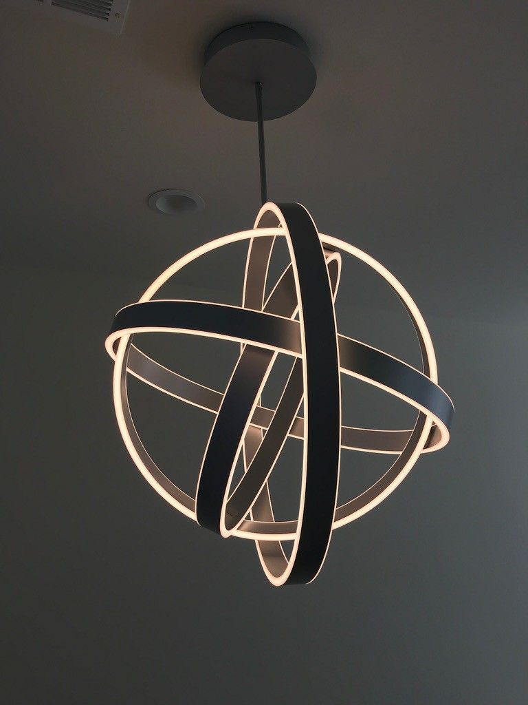 A light hanging from the ceiling in the shape of a sphere