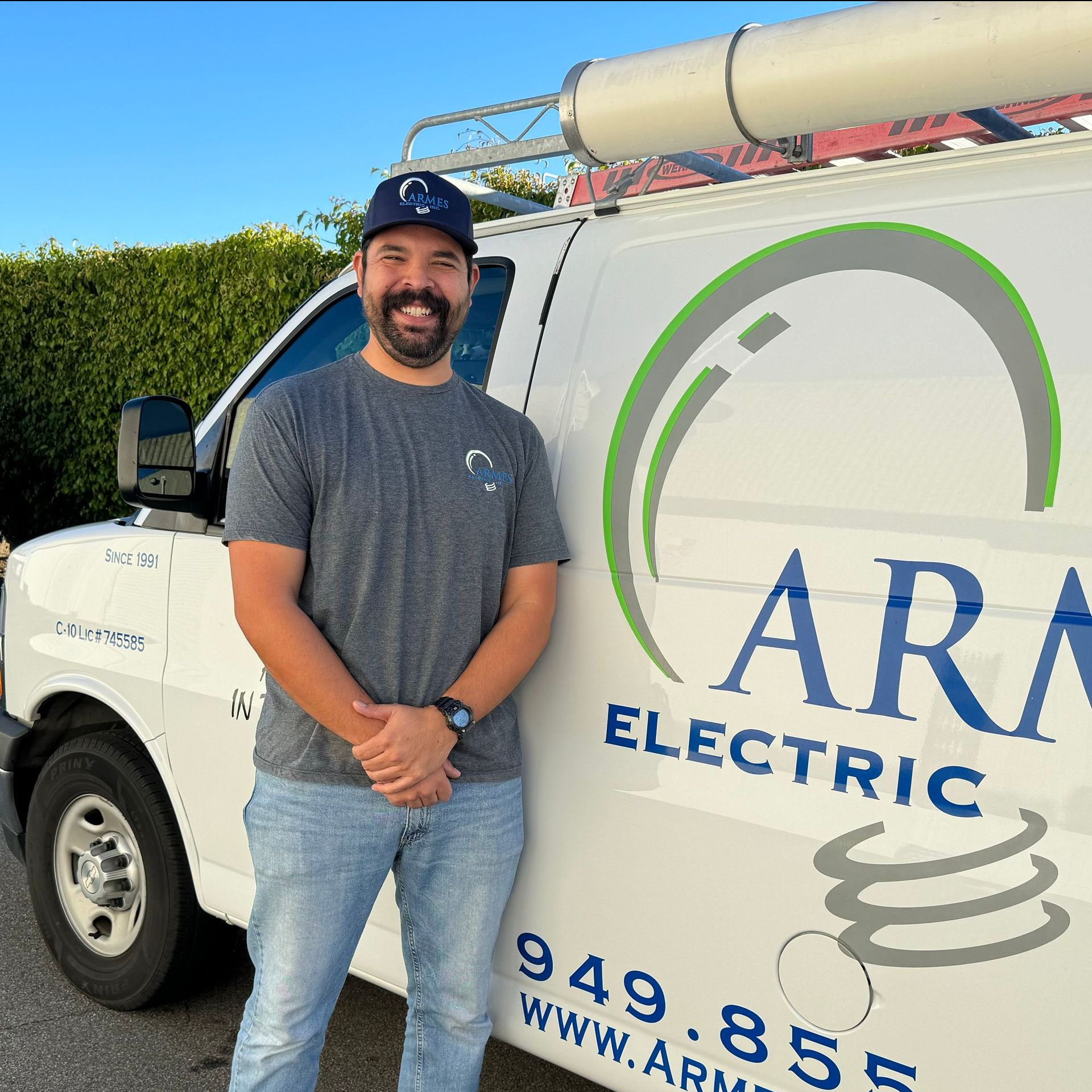 a man stands in front of an armes electric van