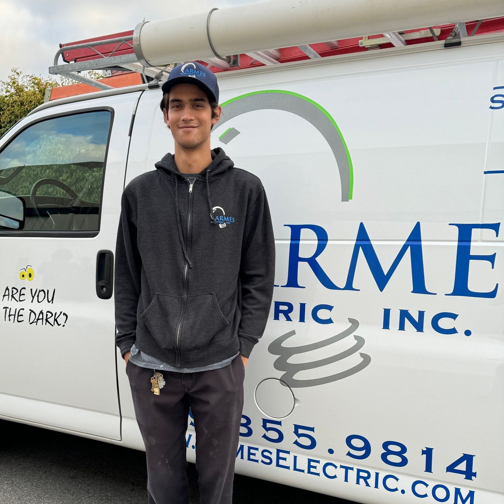 a man stands in front of an armes electric van