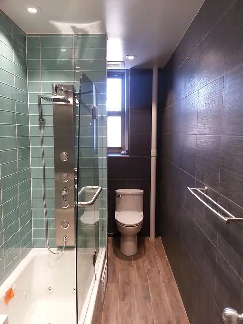 A bathroom with a toilet, tub and shower.