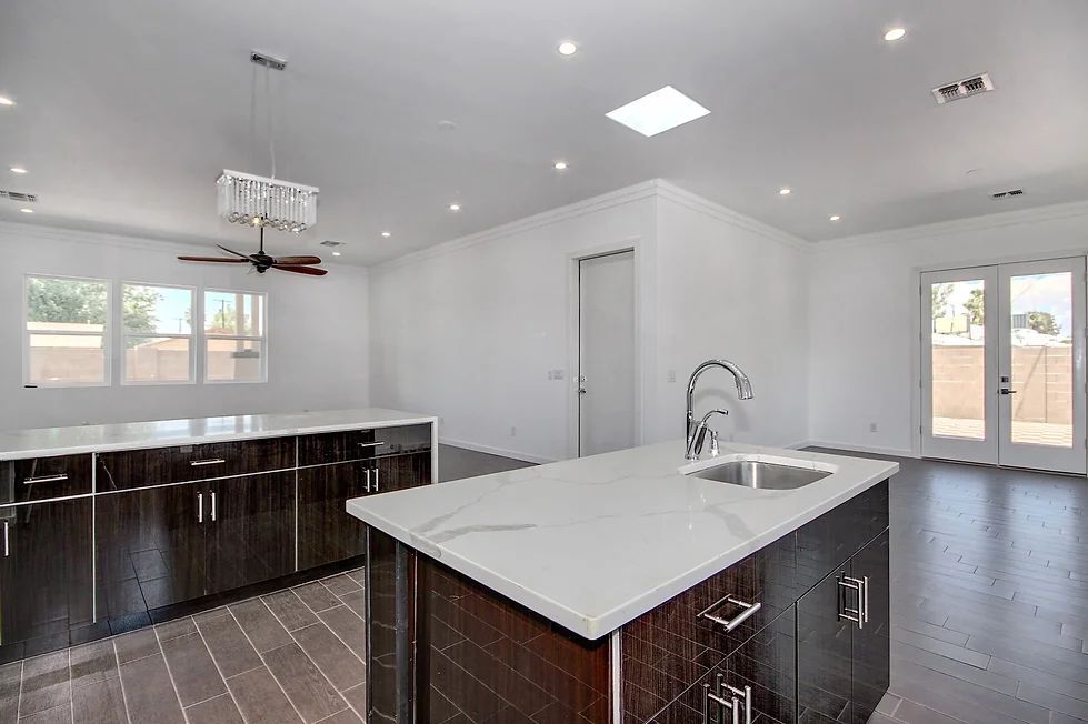 A kitchen with a large island and a sink.