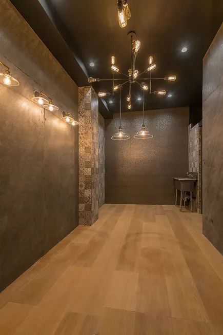 A kitchen with a stainless steel refrigerator, stove, table and chairs.