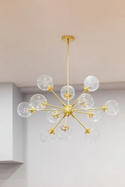 A kitchen with wooden cabinets, a stove, and a window.