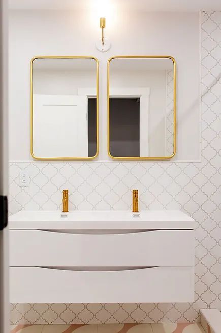 A kitchen with wooden cabinets and a large island in the middle.