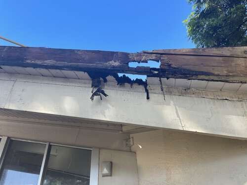 There is a hole in the roof of a house.