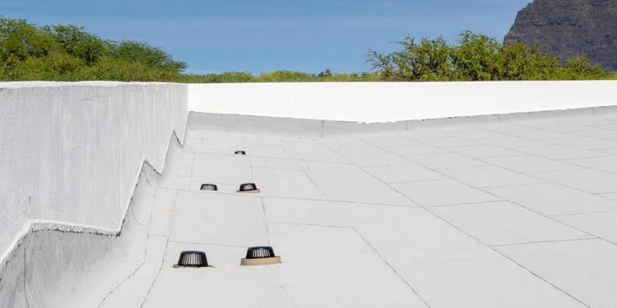 A white roof with a mountain in the background.