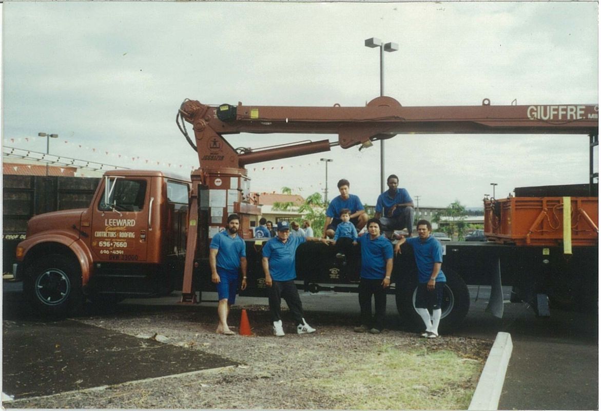 A group of men standing in front of a clift truck