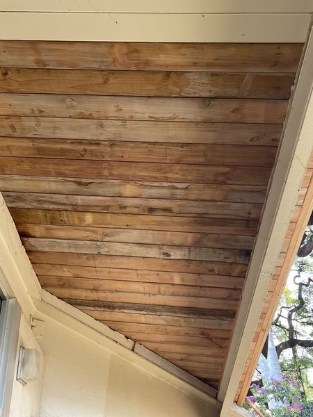 A close up of a wooden ceiling on a porch.