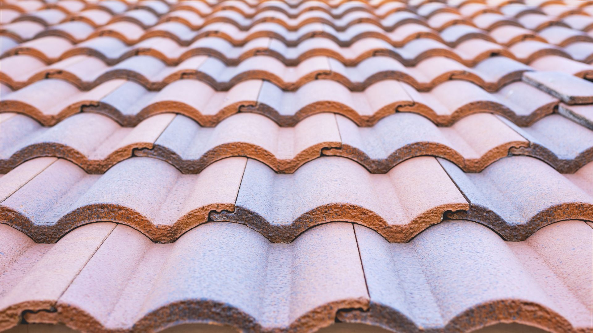Clay tile roof in shades of brown and white, creating a wavy pattern.
