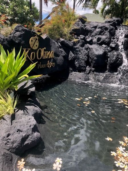 A waterfall in front of a sign that says koolina