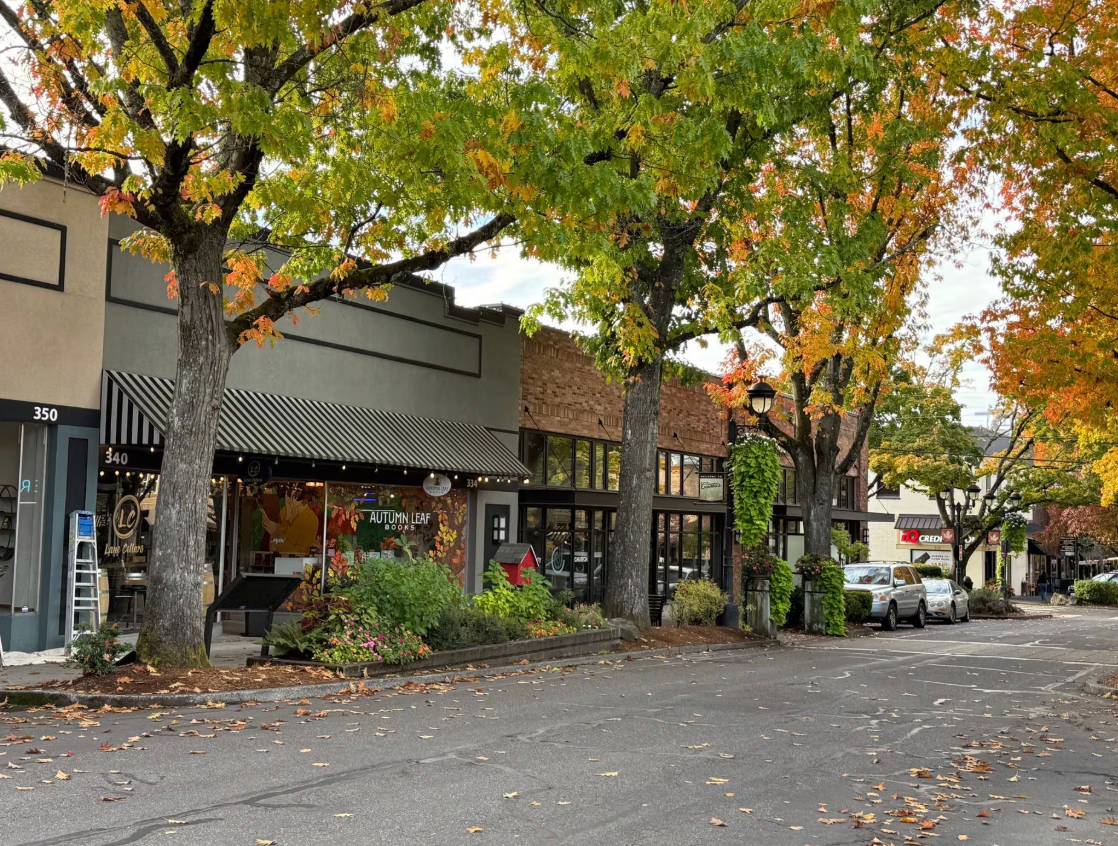 Photo of a person checking out clothes on a clothing rack in a store