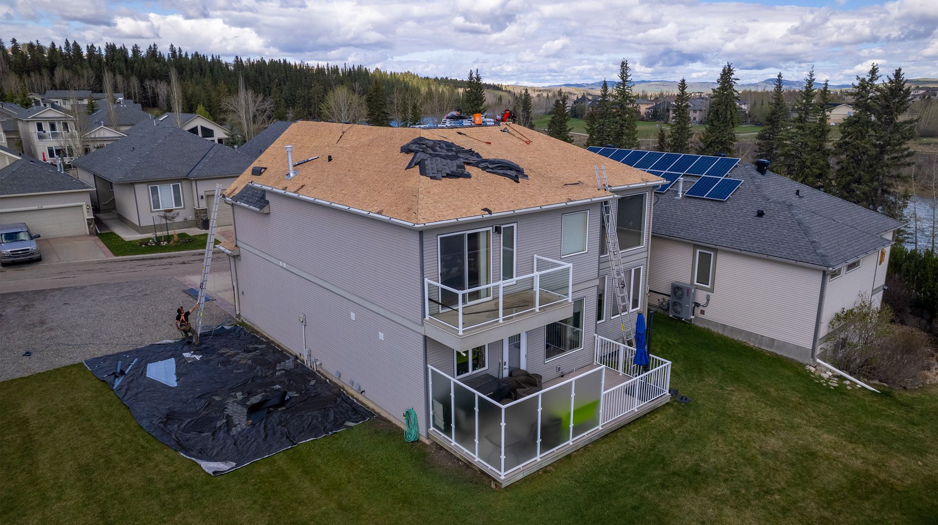 An aerial view of a house with a roof being replaced