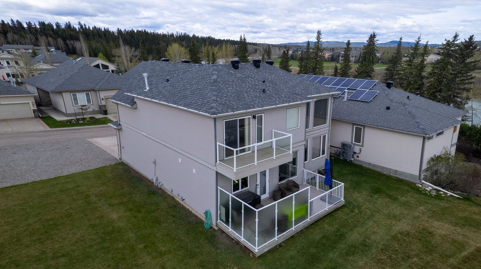 An aerial view of a house with a brand new gray roof