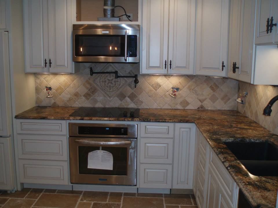 Kitchen with light gray cabinets, brown countertop, and stainless steel appliances.