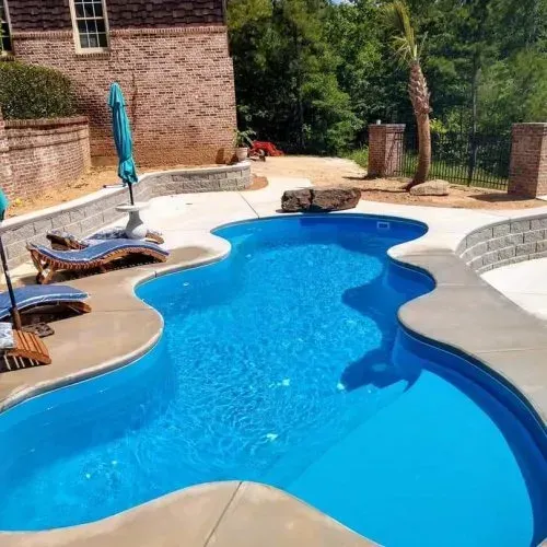 freeform pool with concrete walkways