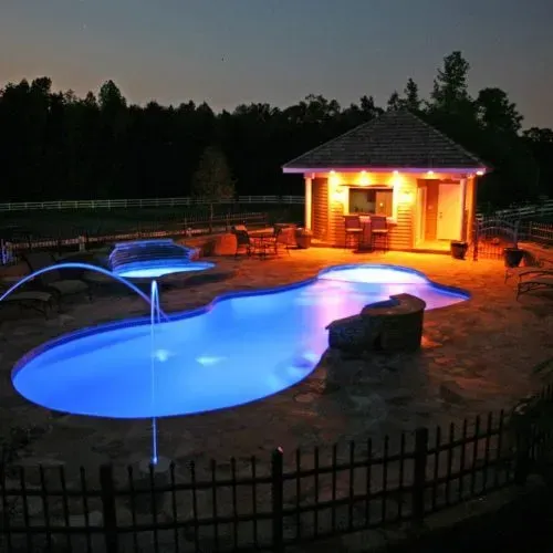 The Pleasure Island pool set up with water features and a pool house in the background