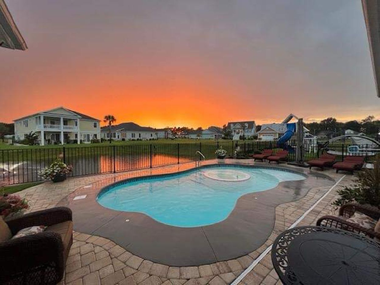 inground pool at sunset on a commercial property