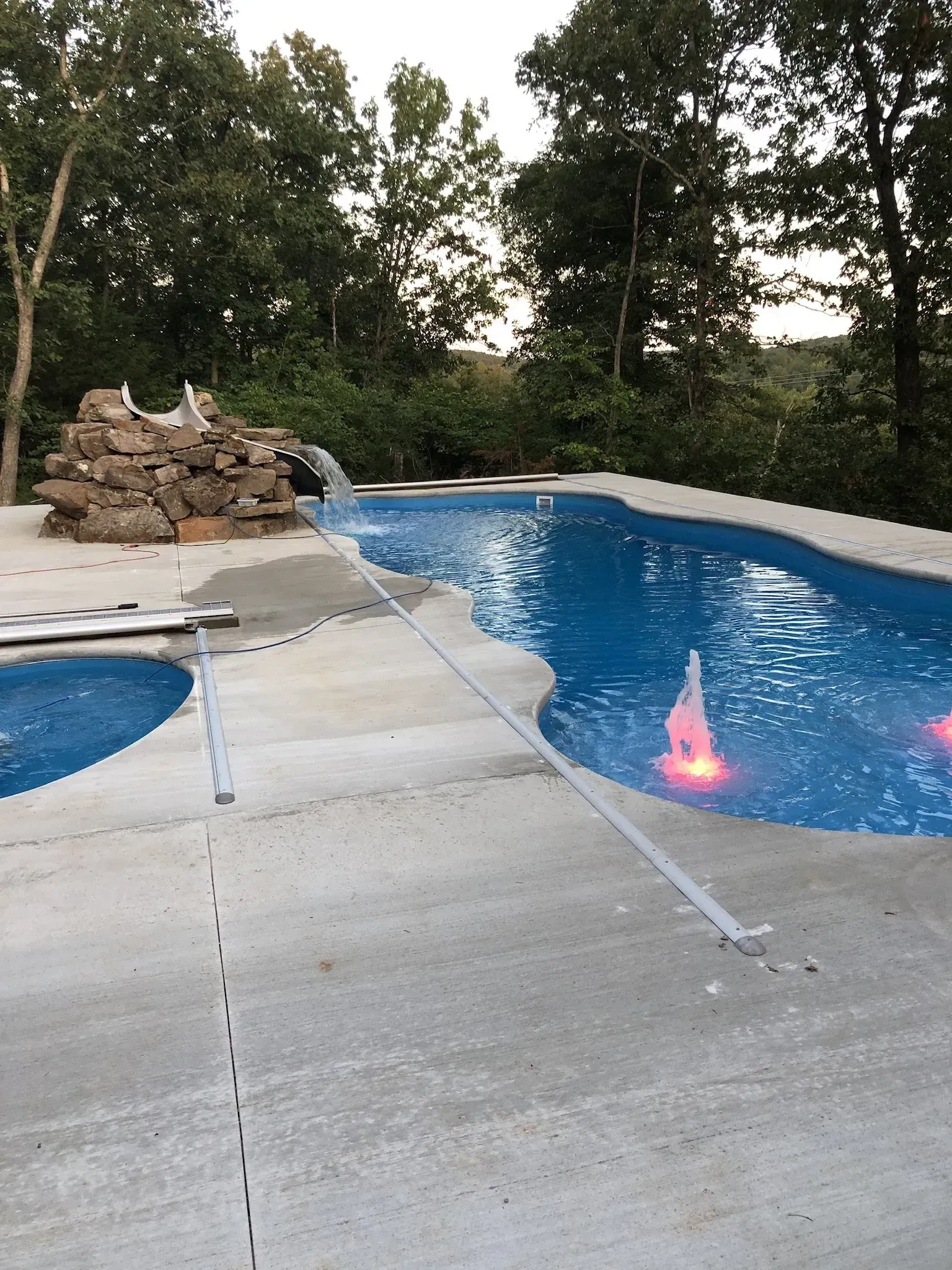 freeform pool with slide and accompanied spa