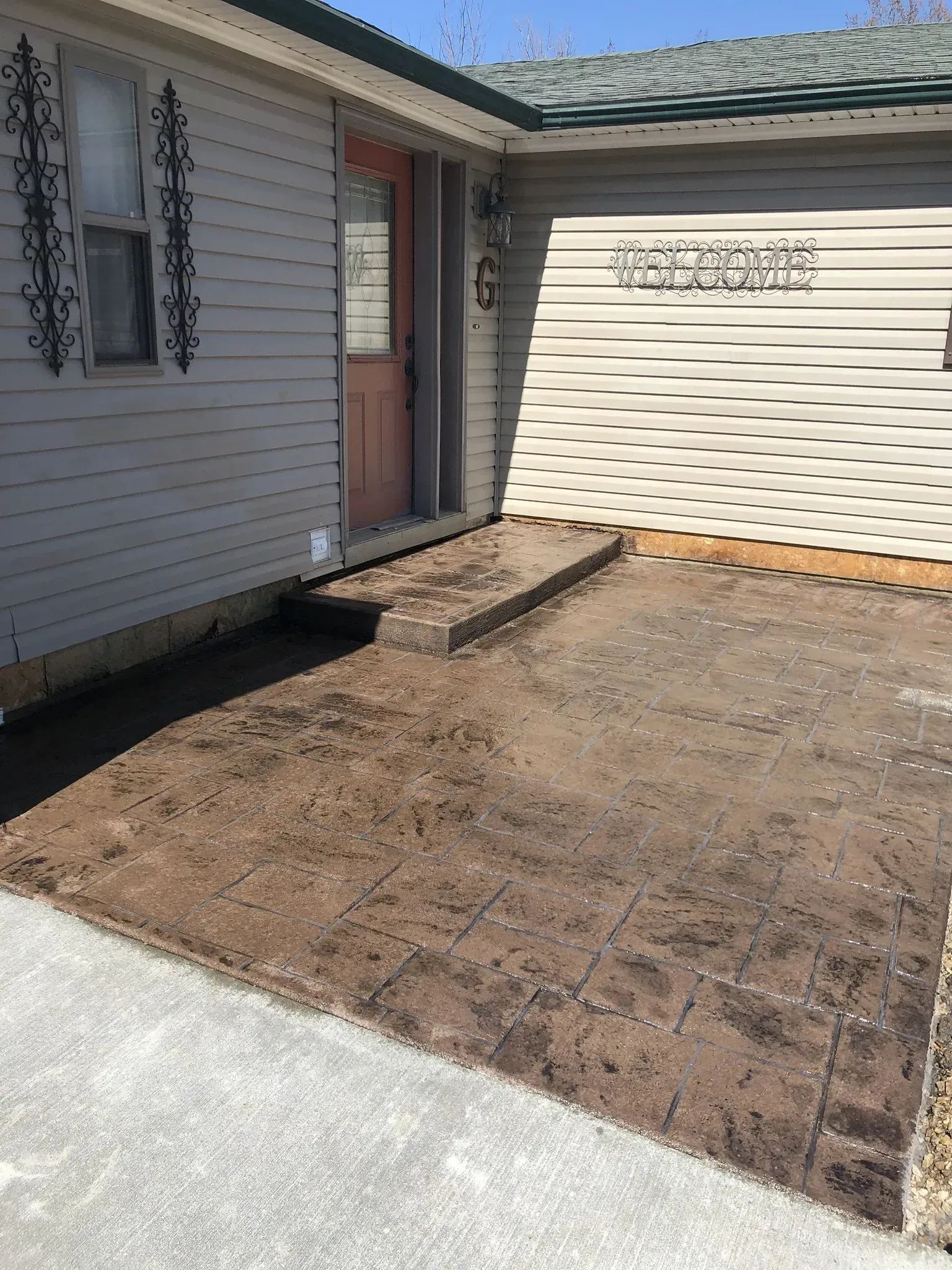 stamped and stained concrete with front door